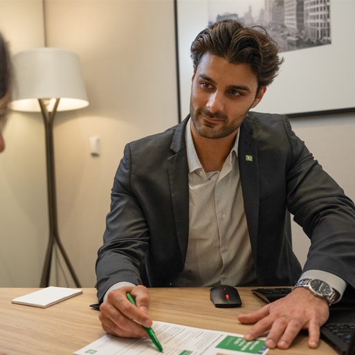 Business banking A TD colleague visits a client at their home to review some financial paperwork.