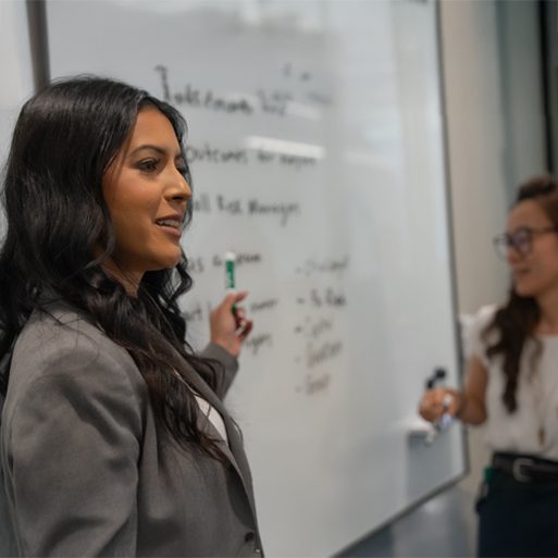 TD securities A colleague looks at her laptop while seated at a desk in a TD office.