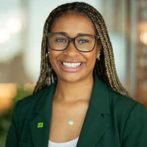 awards3 A colleague with a green TD lapel pin smiles at the camera in a TD office.