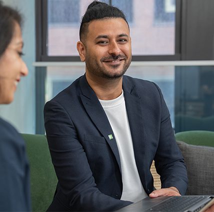 impact A TD employee gives out a booklet while helping a customer.