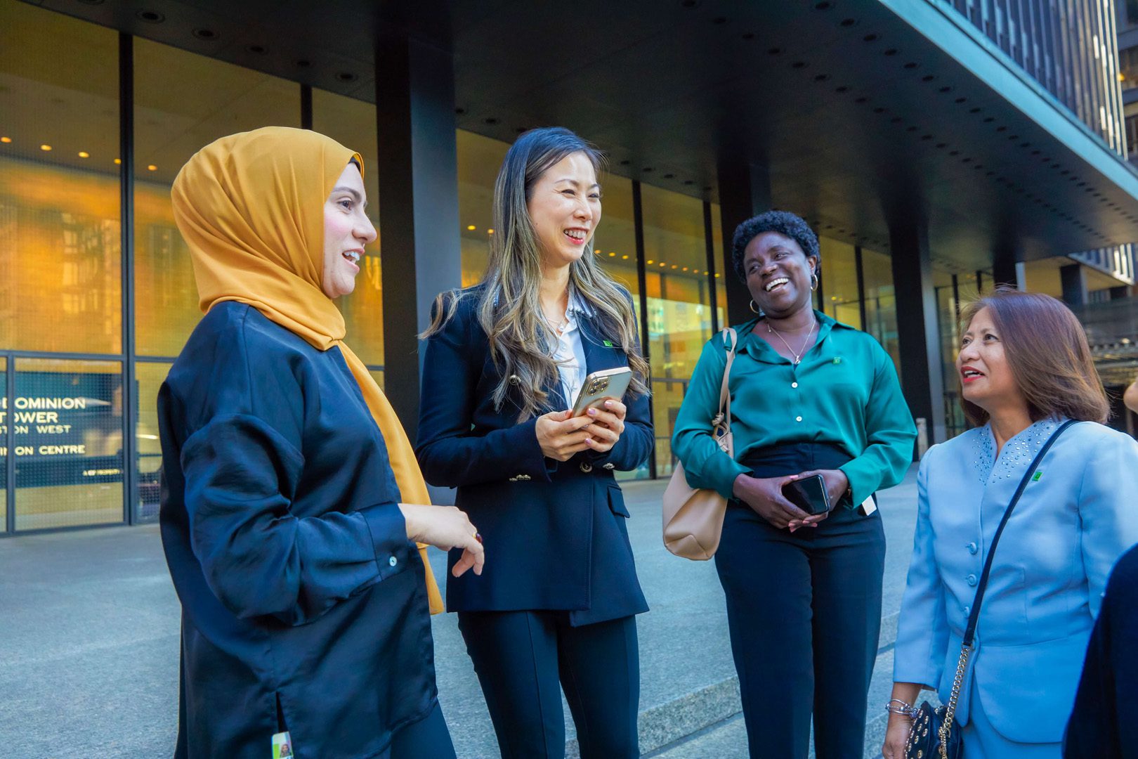 A group of colleagues have a conversation outside of TD head office.