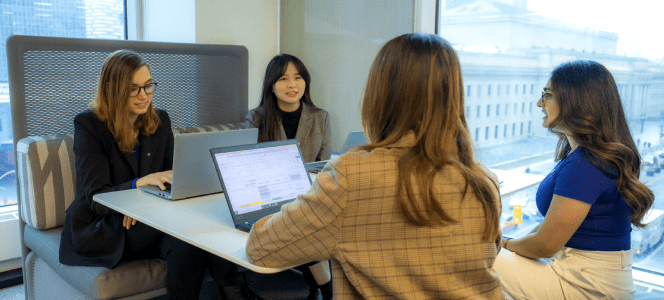 Members of an HR team share a discussion with two new colleagues.