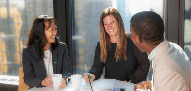 Colleagues share a laugh while working together in a TD office.