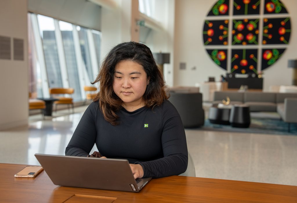 A TD colleague smiles while speaking with a coworker. 